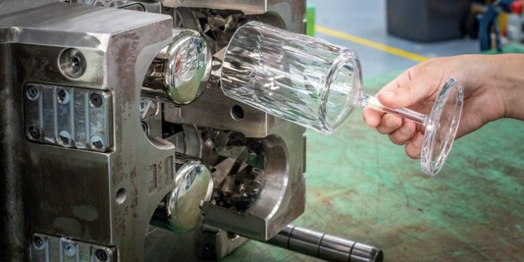 Glass is being shaped by the machine